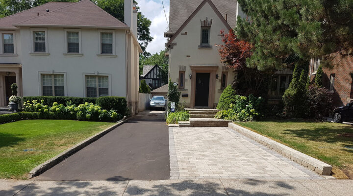 Landscaping Toronto - A driveway leading to a house with a car parked next to it.