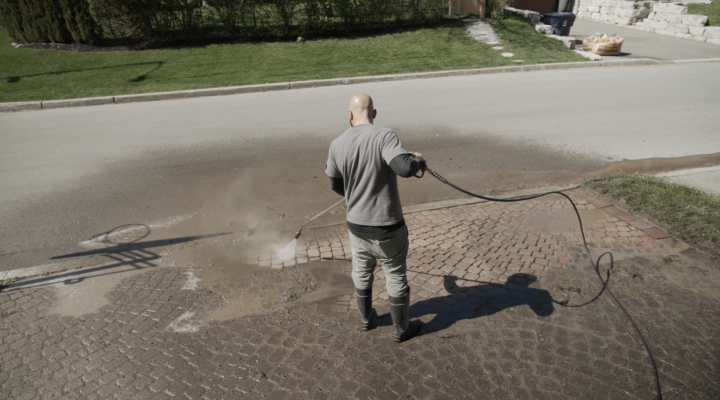 Landscaping Toronto - A man power washing the street.